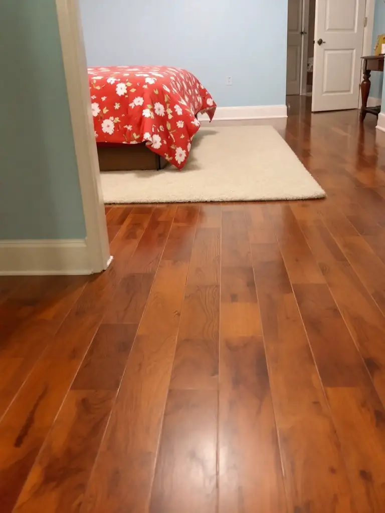 Guest bedroom with wooden floor and contrasting painted walls and bedding